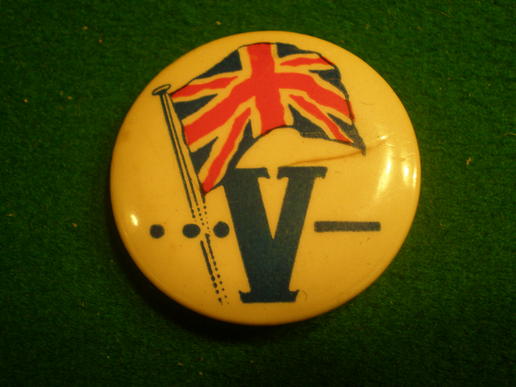 V for victory pin badge.